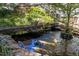 Scenic view of the koi pond, showing the bridge, rocks and colorful fish at 924 Pebblebrook Dr, Raleigh, NC 27609