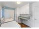 Bright laundry room with washer, dryer, countertop, and storage cabinets at 924 Pebblebrook Dr, Raleigh, NC 27609