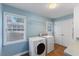 Efficient laundry room with side-by-side washer and dryer and double door at 924 Pebblebrook Dr, Raleigh, NC 27609