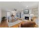 Comfortable living room with a fireplace, a ceiling fan, hardwood floors and large windows at 924 Pebblebrook Dr, Raleigh, NC 27609