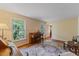 Bright living room with natural light, piano, and hardwood floors, creating a welcoming atmosphere at 924 Pebblebrook Dr, Raleigh, NC 27609