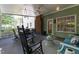 View of screened porch with seating, ceiling fan, and outdoor furniture at 924 Pebblebrook Dr, Raleigh, NC 27609