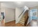 Carpeted stairway with wooden railing leads to the upper level with access to the bedroom at 924 Pebblebrook Dr, Raleigh, NC 27609