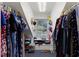 Bright walk-in closet featuring shelving, storage, window and clothes racks at 924 Pebblebrook Dr, Raleigh, NC 27609