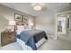 Comfortable bedroom featuring a metal headboard, natural light, and a view of the upstairs hallway at 9513 Wood River Dr, Zebulon, NC 27597