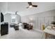 Bright bonus room offers a comfortable seating area, desk, and modern ceiling fans at 9513 Wood River Dr, Zebulon, NC 27597