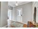 Bright foyer with hardwood floors, modern light fixture, and view to the rest of the house at 9513 Wood River Dr, Zebulon, NC 27597