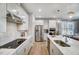 Modern kitchen with stainless steel appliances, white cabinets, and a marble countertop island at 9513 Wood River Dr, Zebulon, NC 27597