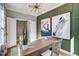 Stylish home office featuring wainscoting, unique light fixture, and custom horse artwork at 9513 Wood River Dr, Zebulon, NC 27597
