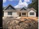 Charming single-story home with navy blue shutters and gables, complemented by a landscaped yard at 987 Lewis Rd, Zebulon, NC 27597