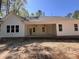 Rear exterior featuring a covered porch with ceiling fans and a view of the backyard at 987 Lewis Rd, Zebulon, NC 27597
