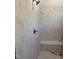 Shower featuring marble-look tiled walls, a rainfall shower head, and a built-in bench at 987 Lewis Rd, Zebulon, NC 27597