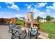Landscaped backyard with outdoor fireplace, lounge area, and green lawn at 104 Bollienger Dr, Princeton, NC 27569