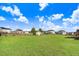 Large backyard featuring a shed surrounded by green grass and residential properties, offering ample outdoor space at 104 Bollienger Dr, Princeton, NC 27569