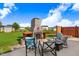 Landscaped backyard with outdoor fireplace, lounge area, and green lawn at 104 Bollienger Dr, Princeton, NC 27569