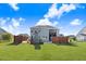 Spacious backyard featuring a pool, stone fireplace, and a wooden privacy fence, perfect for outdoor entertaining at 104 Bollienger Dr, Princeton, NC 27569