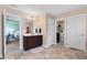 Bright bathroom with brown vanity and marble-look tile floor; bedroom visible in mirror at 104 Bollienger Dr, Princeton, NC 27569