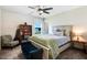 Bright bedroom with a large window, cozy chair, a wood-framed bed with stylish bedding, and a ceiling fan at 104 Bollienger Dr, Princeton, NC 27569