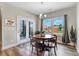 Bright dining area features stylish lighting, wood floors, and views to the outdoor patio area at 104 Bollienger Dr, Princeton, NC 27569
