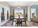Bright dining area features stylish lighting, wood floors, and views to the outdoor patio area at 104 Bollienger Dr, Princeton, NC 27569