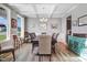 Bright dining room features coffered ceilings, wood floors, and updated lighting fixture at 104 Bollienger Dr, Princeton, NC 27569