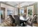 Elegant dining room with coffered ceilings, large windows, and hardwood floors that exudes sophistication and charm at 104 Bollienger Dr, Princeton, NC 27569