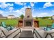 Outdoor fireplace featuring a stone surround and built-in wood storage creating an inviting backyard at 104 Bollienger Dr, Princeton, NC 27569