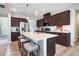 Stylish kitchen with dark wood cabinets, large island, stainless steel appliances, and breakfast bar at 104 Bollienger Dr, Princeton, NC 27569