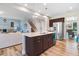 Modern kitchen flows into the living area with island seating and stainless steel appliances at 104 Bollienger Dr, Princeton, NC 27569