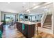 Open-concept kitchen and living room boasts an island with seating, and a seamless flow for modern living at 104 Bollienger Dr, Princeton, NC 27569