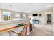 Bright living room with large windows, plush carpet, and tasteful decor at 104 Bollienger Dr, Princeton, NC 27569