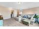 Bright living room with plush seating, neutral tones, carpeted floors, and a laundry room in the background at 104 Bollienger Dr, Princeton, NC 27569