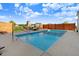 Backyard pool area with lounge chairs, a built-in outdoor kitchen, and outdoor dining at 104 Bollienger Dr, Princeton, NC 27569