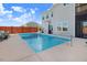 Backyard pool area with lounge chairs, a built-in outdoor kitchen, and privacy fence at 104 Bollienger Dr, Princeton, NC 27569