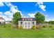 Well-maintained storage shed with a metal roof and double doors, nestled in a green yard under a bright blue sky at 104 Bollienger Dr, Princeton, NC 27569