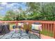 Charming back deck furnished with chairs and a rug, perfect for enjoying outdoor living at 109 Troyer Pl, Apex, NC 27502