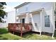 Back of house shows wooden deck, sliding glass doors, and neutral siding with green grass and trees at 109 Troyer Pl, Apex, NC 27502
