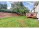 Wide view of the backyard, showcasing the deck and grassy lawn at 109 Troyer Pl, Apex, NC 27502