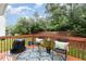 The outdoor deck features patio furniture, planters, and grill overlooking the greenery backyard at 109 Troyer Pl, Apex, NC 27502