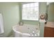 This bathroom features a soaking tub next to a window for natural light and spa-like feel at 109 Troyer Pl, Apex, NC 27502