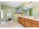 Bright bathroom featuring a double sink vanity, soaking tub, and tiled floors at 109 Troyer Pl, Apex, NC 27502