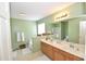 Bright and clean bathroom with double sink vanity, large mirror, and a separate shower at 109 Troyer Pl, Apex, NC 27502