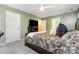 Inviting bedroom includes decorative bed and ceiling fan and provides ample natural light at 109 Troyer Pl, Apex, NC 27502