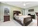 Well-lit bedroom with a decorative ceiling fan, wooden furniture and an ample window view at 109 Troyer Pl, Apex, NC 27502