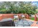 Inviting outdoor deck featuring seating, a rug, and a grill, perfect for entertaining and relaxation at 109 Troyer Pl, Apex, NC 27502