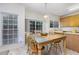 Sunlit dining area with tiled floors, backyard access, and matching table set at 109 Troyer Pl, Apex, NC 27502