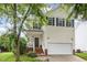 Charming two-story home with a well-maintained lawn and an attached two-car garage at 109 Troyer Pl, Apex, NC 27502