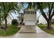 Two-story home featuring a white garage door and black shutters against light siding under a blue sky at 109 Troyer Pl, Apex, NC 27502