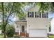 Charming two-story home with a well-maintained lawn and an attached two-car garage at 109 Troyer Pl, Apex, NC 27502