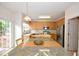 Bright eat-in kitchen features stainless steel appliances, a breakfast bar, and a sliding glass door at 109 Troyer Pl, Apex, NC 27502